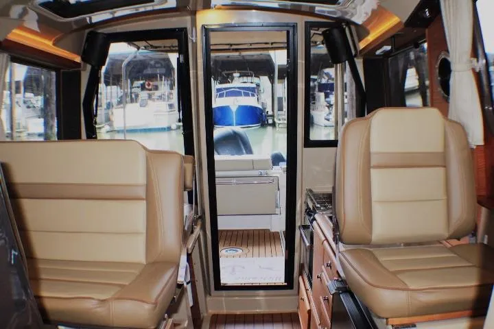 Knot Working Yacht Photos Pics Interior of 2020 Ranger Tugs R-27 boat with tan seating and marina view.