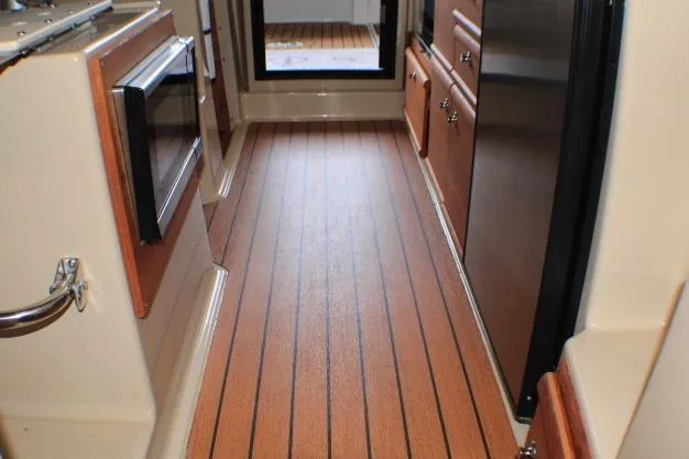 Knot Working Yacht Photos Pics Interior of 2020 Ranger Tugs R-27 boat with wood flooring and cabinetry.