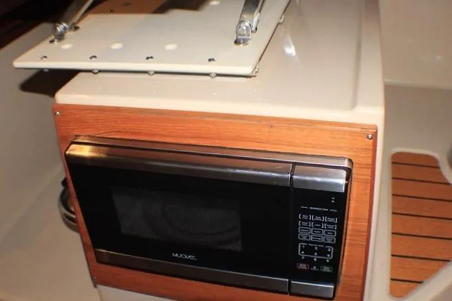 Knot Working Yacht Photos Pics Microwave in 2020 Ranger Tugs R-27 boat interior, featuring wood paneling.