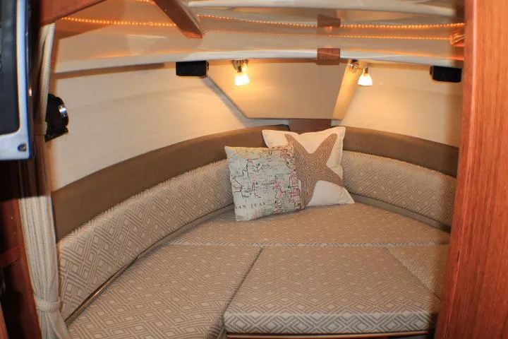 Knot Working Yacht Photos Pics Cozy interior of 2020 Ranger Tugs R-27 boat with cushions and decorative pillows.