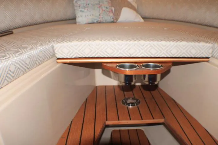 Knot Working Yacht Photos Pics 2020 Ranger Tugs R-27 interior with cushioned seating and wooden flooring.