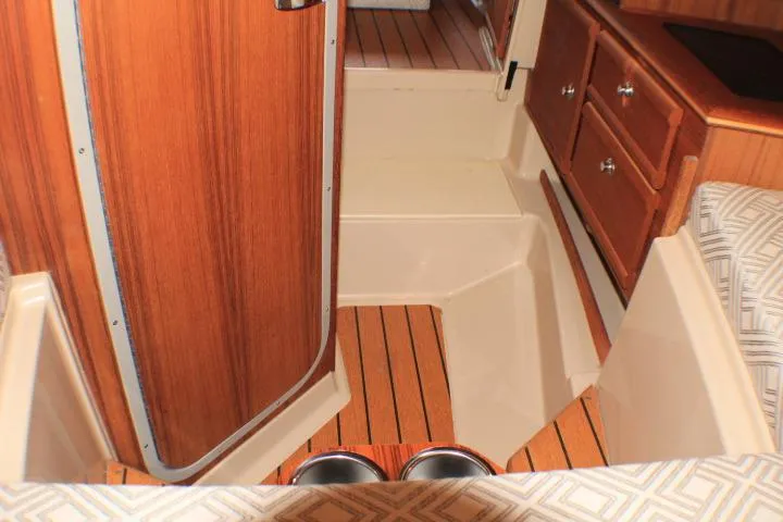 Knot Working Yacht Photos Pics Interior of 2020 Ranger Tugs R-27 boat with wood finish and storage drawers.