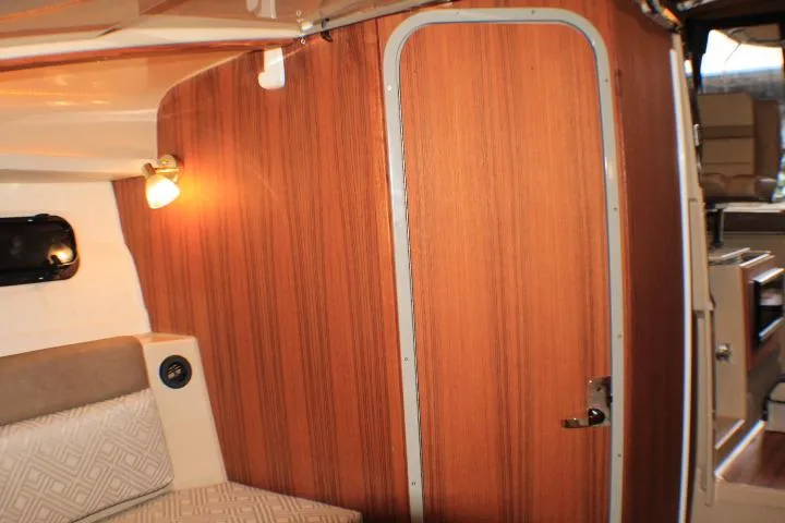 Knot Working Yacht Photos Pics 2020 Ranger Tugs R-27 interior with wood paneling and cozy seating area.