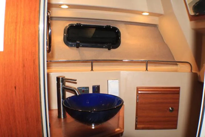 Knot Working Yacht Photos Pics 2020 Ranger Tugs R-27 interior with modern sink and wooden cabinetry.