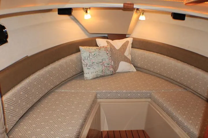 Knot Working Yacht Photos Pics Cozy interior of 2020 Ranger Tugs R-27 with patterned cushions and decorative pillows.