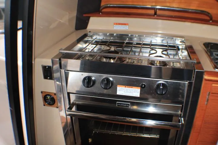 Knot Working Yacht Photos Pics 2020 Ranger Tugs R-27 interior kitchen with stainless steel stove and oven.