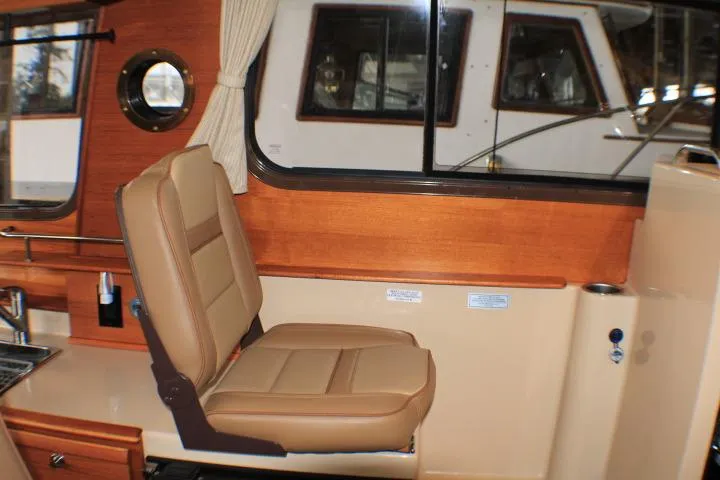 Knot Working Yacht Photos Pics 2020 Ranger Tugs R-27 interior with tan seating and wooden accents.