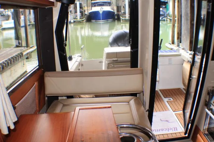 Knot Working Yacht Photos Pics 2020 Ranger Tugs R-27 interior view with docked boats in background.