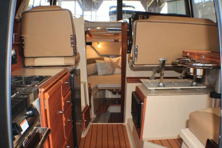 Knot Working Yacht Photos Pics Interior of 2020 Ranger Tugs R-27 boat, featuring cozy cabin and wooden finishes.