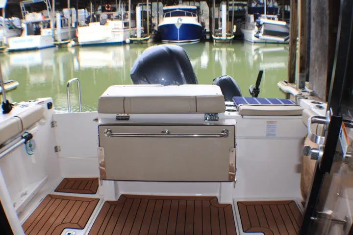 Knot Working Yacht Photos Pics 2020 Ranger Tugs R-27 boat interior with seating, docked at marina.