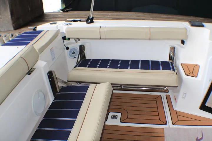 Knot Working Yacht Photos Pics 2020 Ranger Tugs R-27 interior with cushioned seating and wood-style flooring.