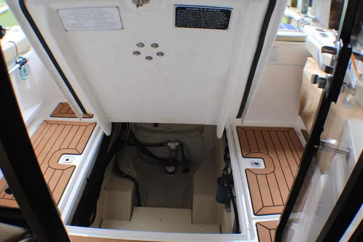 Knot Working Yacht Photos Pics 2020 Ranger Tugs R-27 engine compartment with teak flooring and open hatch.