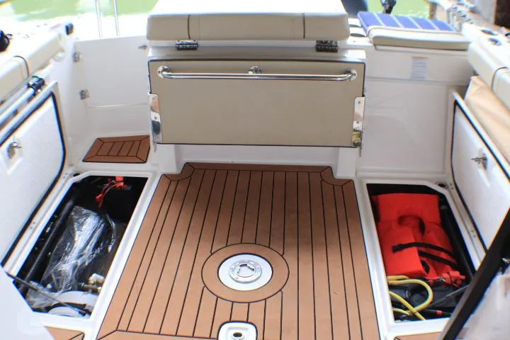 Knot Working Yacht Photos Pics 2020 Ranger Tugs R-27 boat interior with storage compartments and teak flooring.