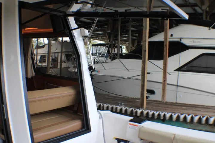 Knot Working Yacht Photos Pics 2020 Ranger Tugs R-27 interior view with docked boats in the background.