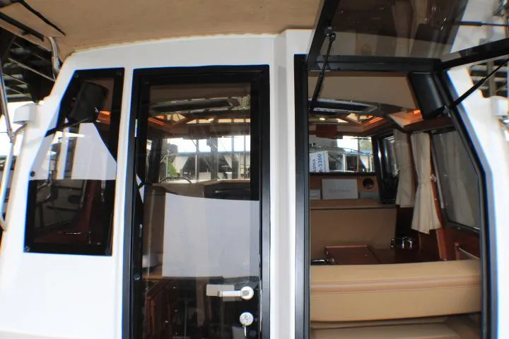 Knot Working Yacht Photos Pics 2020 Ranger Tugs R-27 interior view with open cabin door.