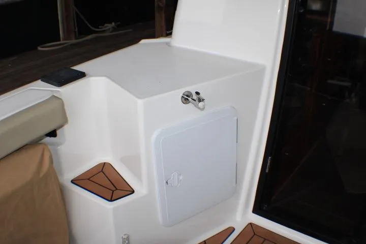 Knot Working Yacht Photos Pics 2020 Ranger Tugs R-27 boat interior with storage compartment and teak accents.