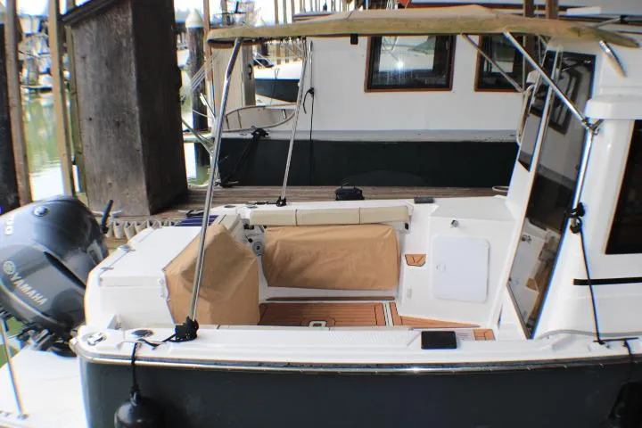 Knot Working Yacht Photos Pics 2020 Ranger Tugs R-27 boat with Yamaha outboard motor, docked at marina.