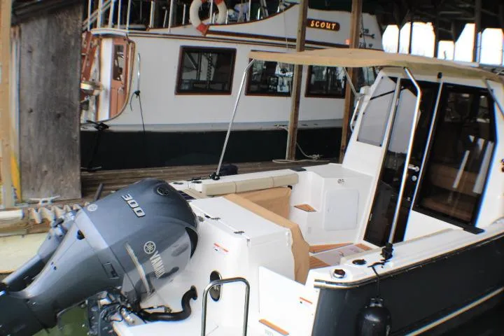 Knot Working Yacht Photos Pics 2020 Ranger Tugs R-27 boat with Yamaha 300 engine, docked in a marina.