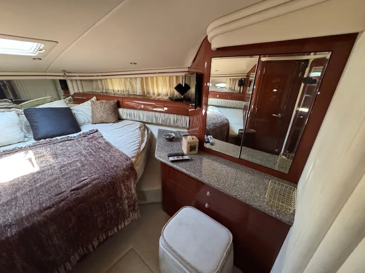Aqueous Ubiquitous Yacht Photos Pics Luxurious 2004 Sea Ray 560 Sedan Bridge bedroom with elegant decor and cozy bedding.