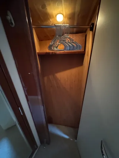 Aqueous Ubiquitous Yacht Photos Pics Wooden closet with hangers inside a 2004 Sea Ray 560 Sedan Bridge yacht.