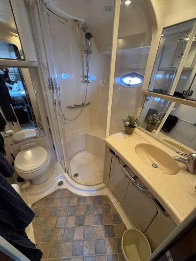 Aqueous Ubiquitous Yacht Photos Pics Bathroom interior of 2004 Sea Ray 560 Sedan Bridge yacht, featuring shower and vanity.