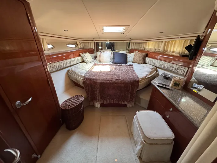 Aqueous Ubiquitous Yacht Photos Pics Luxurious 2004 Sea Ray 560 Sedan Bridge yacht bedroom with elegant decor and plush bedding.