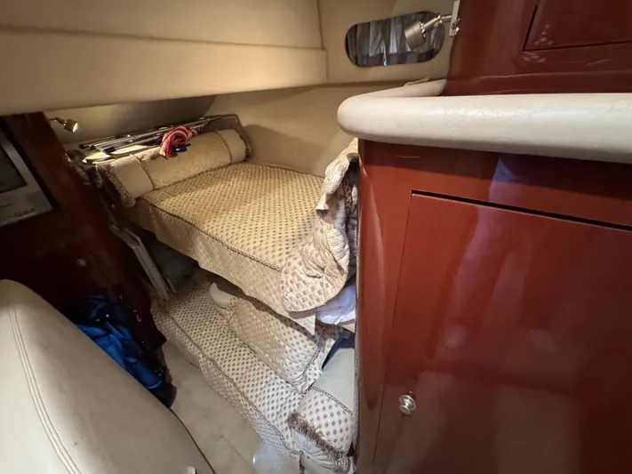 Aqueous Ubiquitous Yacht Photos Pics 2004 Sea Ray 560 Sedan Bridge interior with bunk beds and wooden cabinetry.