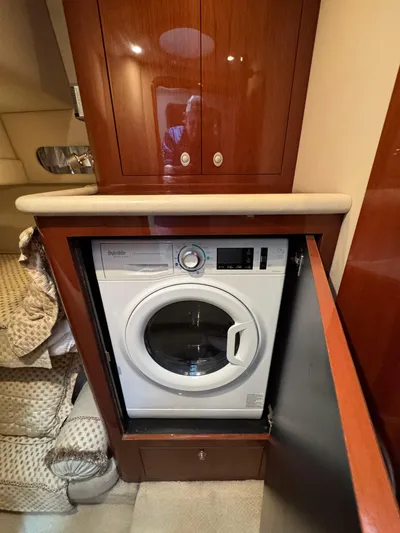 Aqueous Ubiquitous Yacht Photos Pics Washing machine in 2004 Sea Ray 560 Sedan Bridge yacht's wooden cabinet.