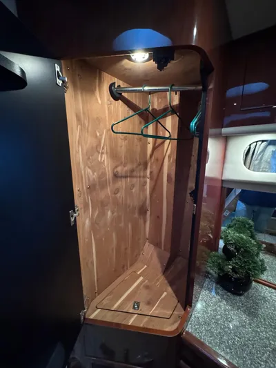 Aqueous Ubiquitous Yacht Photos Pics 2004 Sea Ray 560 Sedan Bridge wooden closet interior with hangers and lighting.