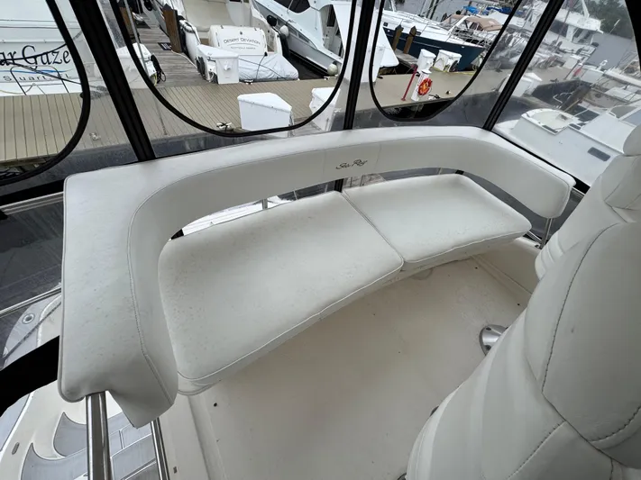 Aqueous Ubiquitous Yacht Photos Pics 2004 Sea Ray 560 Sedan Bridge interior with white seating and marina view.