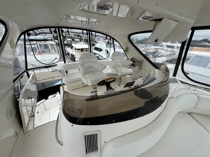 Aqueous Ubiquitous Yacht Photos Pics Luxurious 2004 Sea Ray 560 Sedan Bridge yacht interior with helm and seating area.