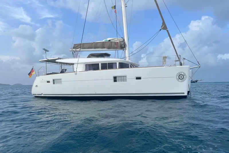  Yacht Photos Pics 2012 Lagoon 400 catamaran sailing on open sea under cloudy skies.