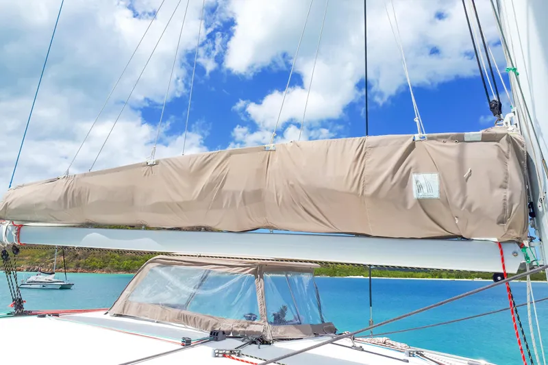  Yacht Photos Pics Sailboat Lagoon 400 (2012) with covered sail, anchored in a scenic bay.