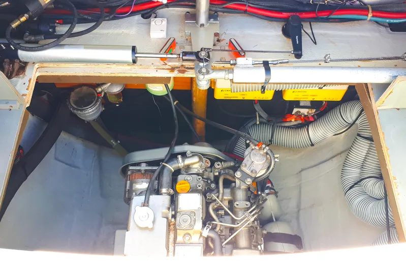  Yacht Photos Pics Engine compartment of a 2012 Lagoon 400 catamaran, showcasing mechanical components and wiring.