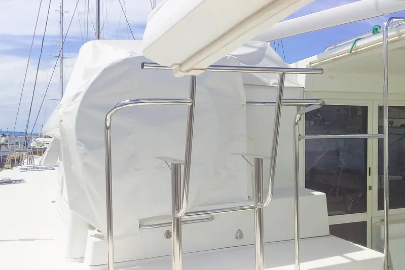  Yacht Photos Pics 2012 Lagoon 400 yacht deck with covered equipment and stainless steel railings.