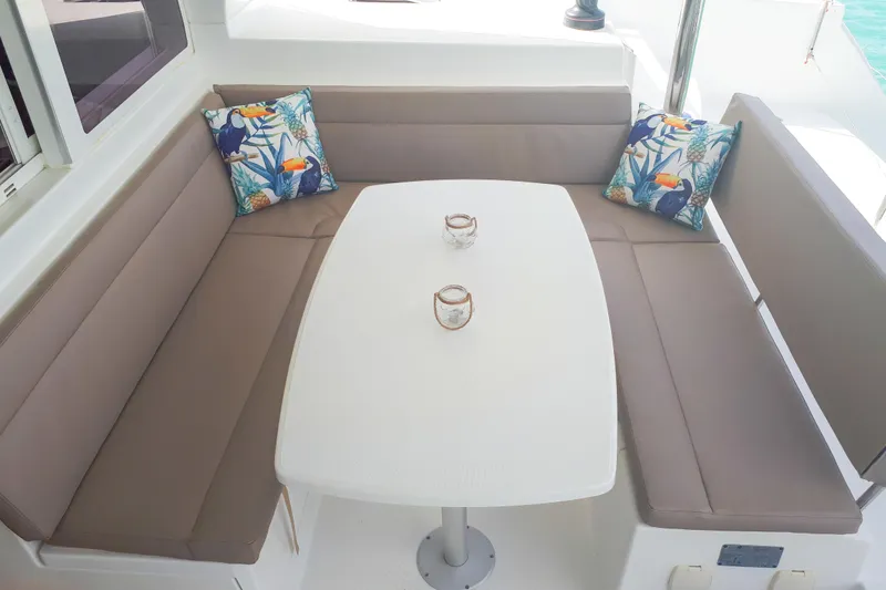  Yacht Photos Pics Cozy seating area on 2012 Lagoon 400 yacht with tropical-themed cushions and table.