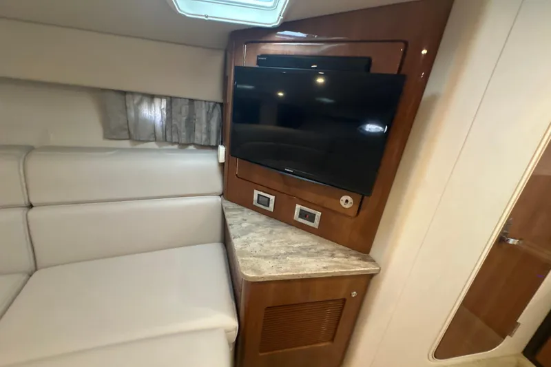  Yacht Photos Pics Interior of 2018 Formula 370 Super Sport with TV, beige seating, and wood accents.
