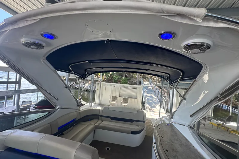  Yacht Photos Pics 2018 Formula 370 Super Sport boat interior with seating and canopy, docked by the water.