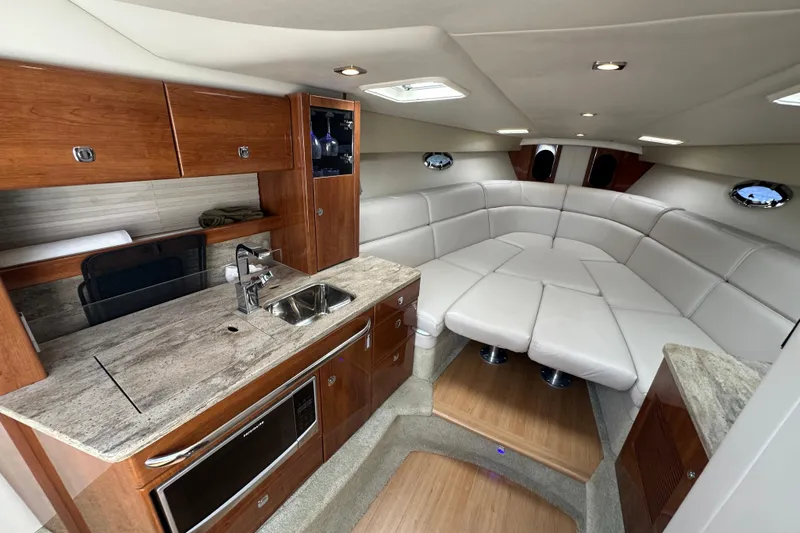  Yacht Photos Pics Luxurious interior of a 2018 Formula 370 Super Sport boat with modern kitchen and seating.