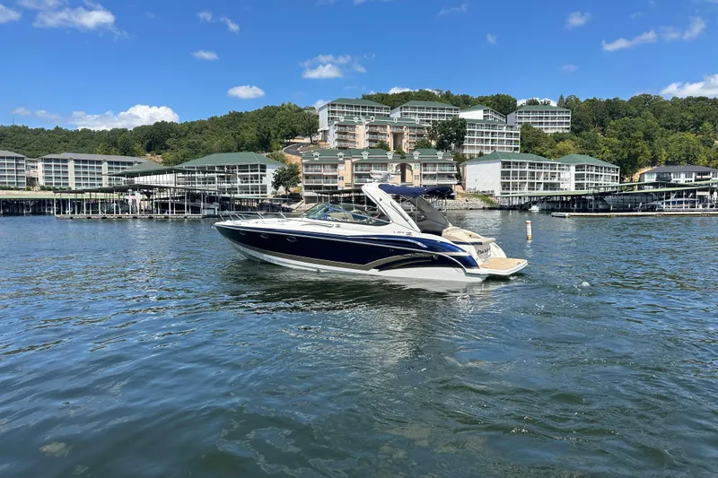  Yacht Photos Pics 2018 Formula 370 Super Sport boat on a scenic lake with waterfront buildings.