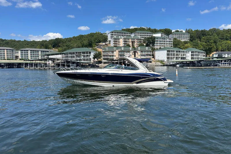  Yacht Photos Pics 2018 Formula 370 Super Sport boat on a lake with waterfront buildings in the background.