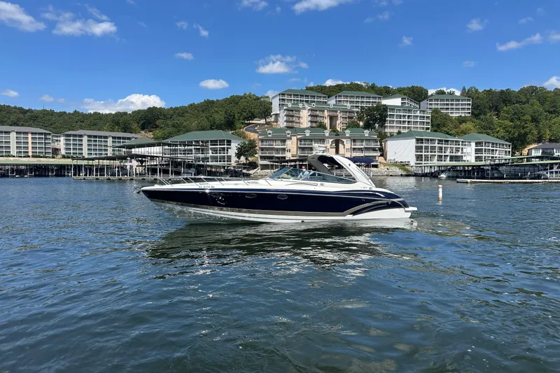  Yacht Photos Pics 2018 Formula 370 Super Sport boat on a scenic lake with buildings in the background.
