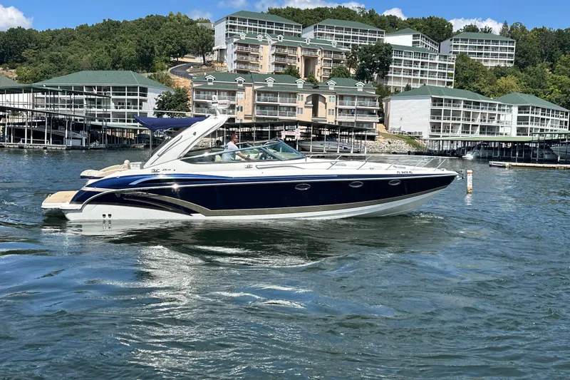  Yacht Photos Pics 2018 Formula 370 Super Sport boat cruising on a lake near waterfront buildings.