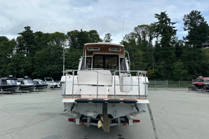  Yacht Photos Pics 2025 Ranger Tugs R-29S boat rear view in a marina setting.