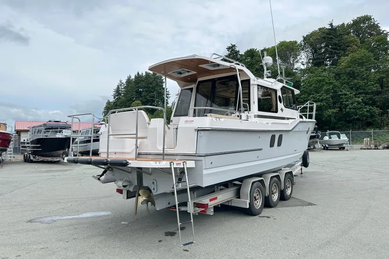  Yacht Photos Pics 2025 Ranger Tugs R-29S boat on trailer in outdoor setting.