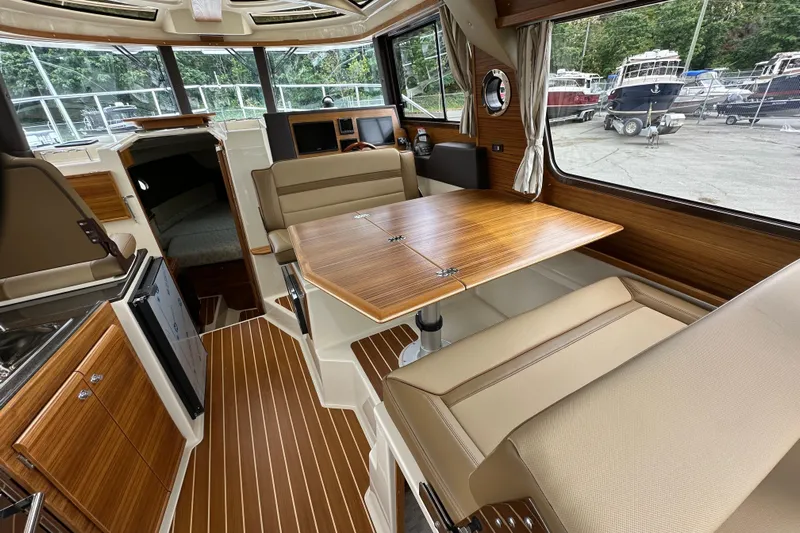  Yacht Photos Pics 2025 Ranger Tugs R-29S interior with wood accents and seating area.