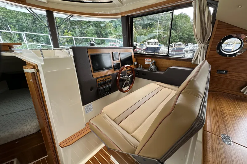  Yacht Photos Pics 2025 Ranger Tugs R-29S helm with modern controls and comfortable seating.