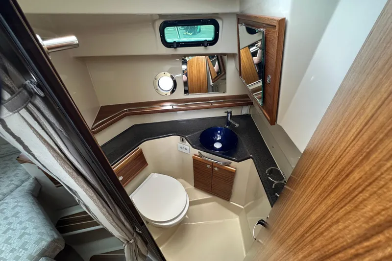  Yacht Photos Pics 2025 Ranger Tugs R-29S bathroom with modern fixtures and wood accents.