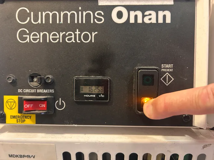 Reel Blessed Yacht Photos Pics Finger pressing start button on Cummins Onan generator.
