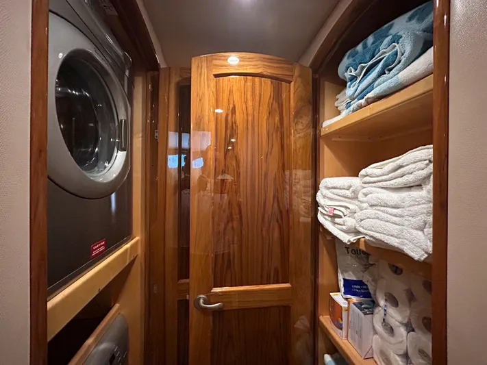 Reel Blessed Yacht Photos Pics Laundry area in a 2014 Viking ENC FB with towels and washing machine.